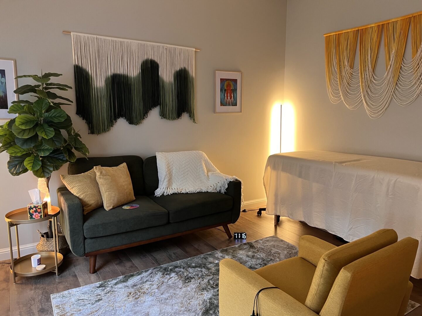 Therapy office with a green couch and woven wall hanging at NATIVation Counseling